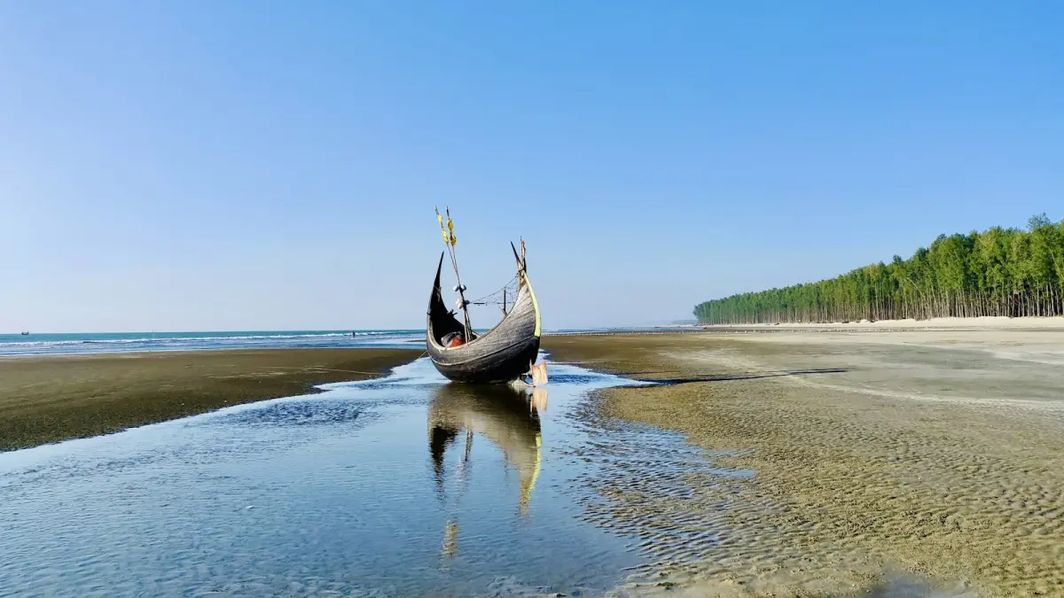 Traditional wooden boat on a beach at low tide