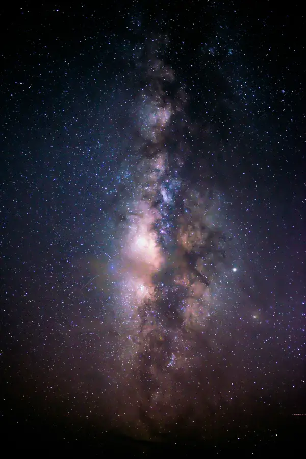 Bright Milky Way galaxy core over a dark horizon