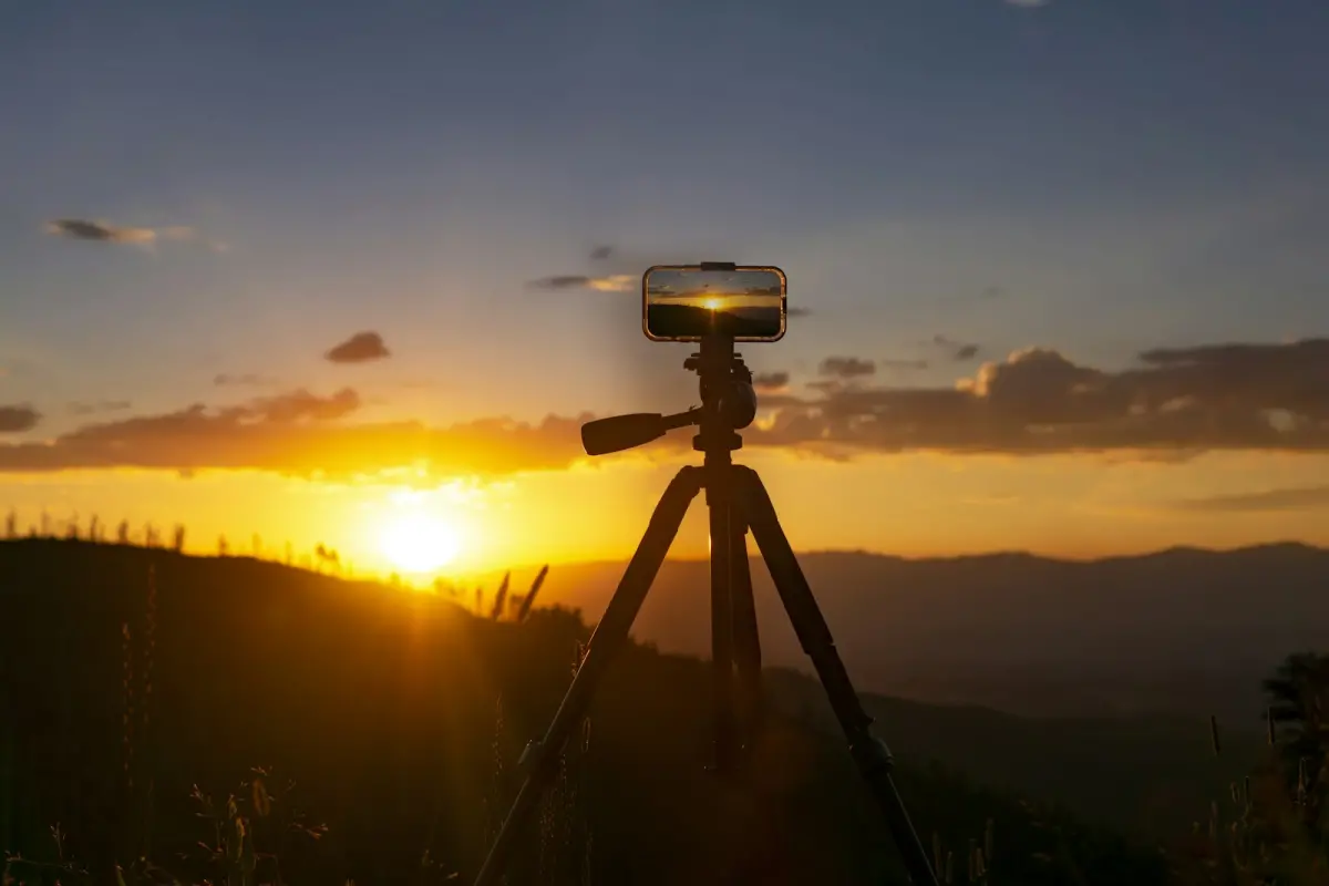 Tripod set up on a hill at sunset